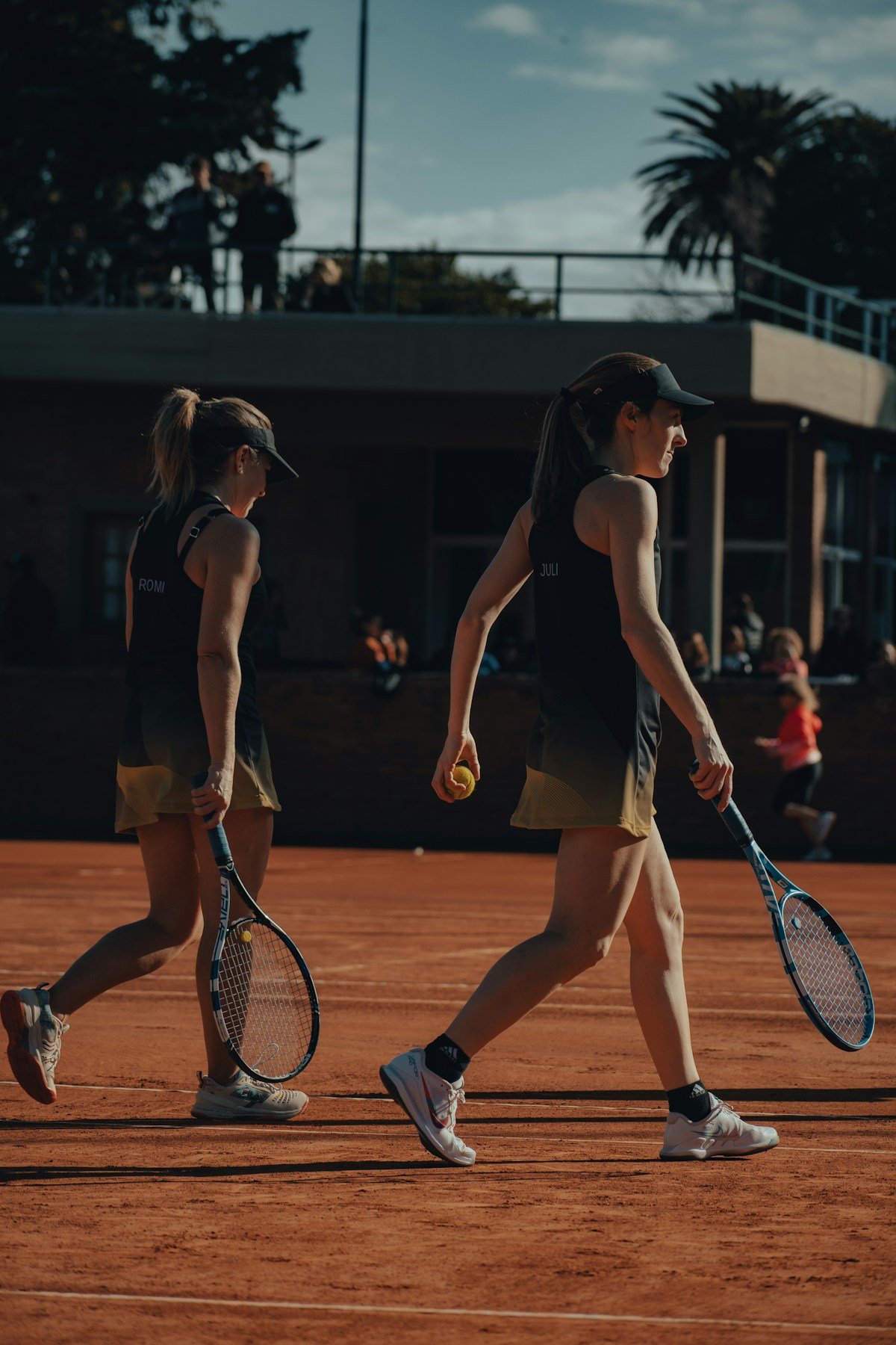 Women playing tennis together on court